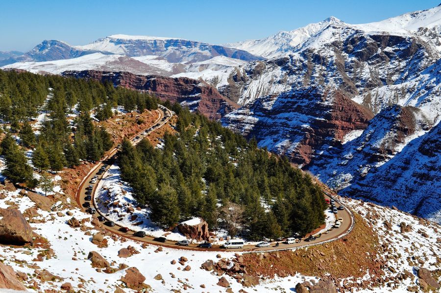 Snow on the High Atlas and a forested mountain road near Oukaïmeden